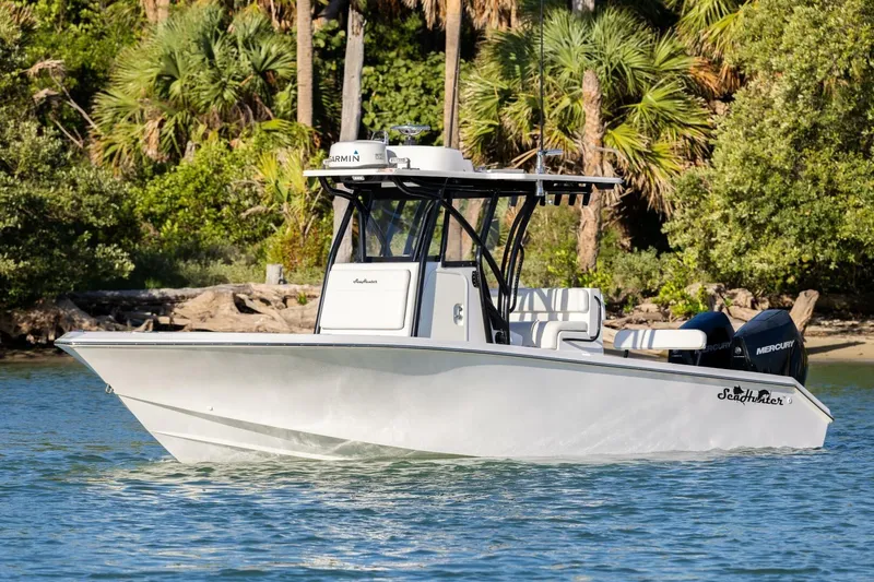  Yacht Photos Pics 2019 SeaHunter 28 Floridian boat cruising on a scenic waterway with lush greenery.