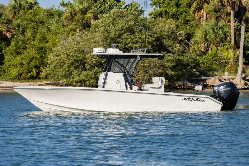  Yacht Photos Pics 2019 SeaHunter 28 Floridian boat on water, surrounded by lush greenery.
