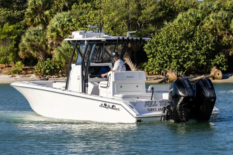  Yacht Photos Pics 2019 SeaHunter 28 Floridian boat cruising near lush shoreline.