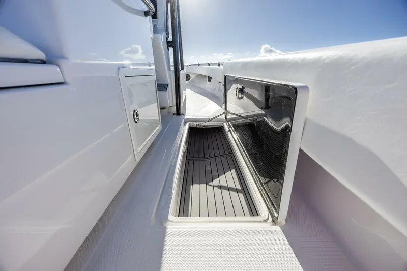  Yacht Photos Pics 2019 SeaHunter 28 Floridian boat storage compartment with open hatch under clear sky.