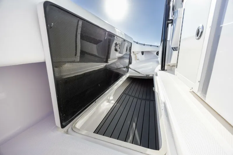  Yacht Photos Pics 2019 SeaHunter 28 Floridian boat storage compartment, open with sleek black interior.