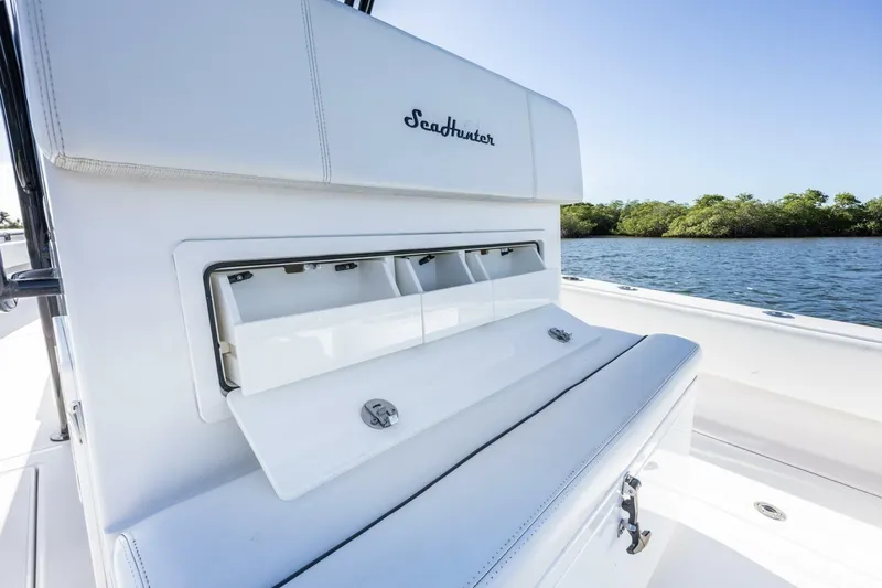  Yacht Photos Pics 2019 SeaHunter 28 Floridian boat interior with storage compartment, on calm water.