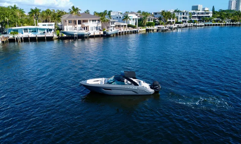 Tgis Yacht Photos Pics 2021 Cruisers Yachts 338 South Beach Edition Bow Rider on a scenic waterfront.