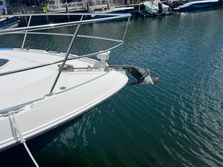 Yacht Photos Pics Bow of 2013 Sea Ray 410 Sundancer with anchor, docked in calm water.