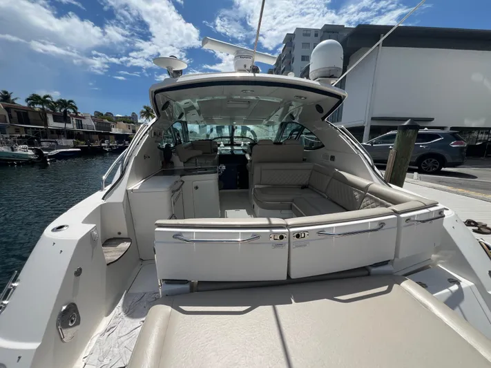  Yacht Photos Pics 2013 Sea Ray 410 Sundancer yacht with spacious seating, docked under a clear blue sky.