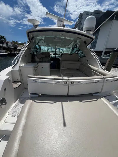  Yacht Photos Pics 2013 Sea Ray 410 Sundancer yacht with spacious seating and modern amenities under a clear sky.