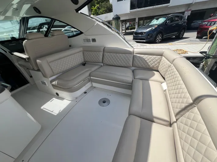  Yacht Photos Pics Luxurious interior seating of 2013 Sea Ray 410 Sundancer yacht, featuring beige upholstery.