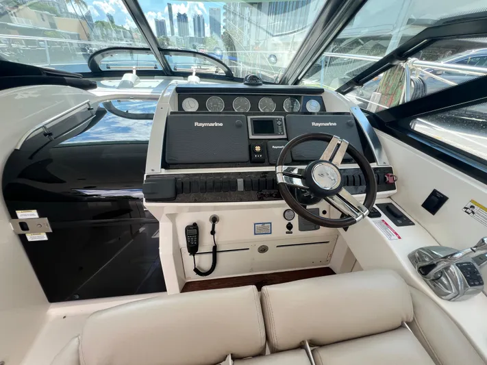  Yacht Photos Pics 2013 Sea Ray 410 Sundancer helm with Raymarine electronics and modern steering wheel.