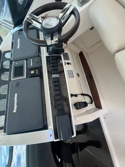  Yacht Photos Pics 2013 Sea Ray 410 Sundancer helm with Raymarine electronics and steering wheel.