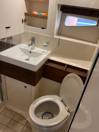  Yacht Photos Pics Bathroom interior of 2013 Sea Ray 410 Sundancer yacht, featuring sink and toilet.