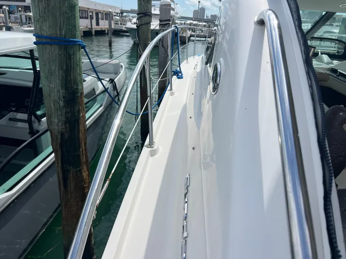  Yacht Photos Pics 2013 Sea Ray 410 Sundancer yacht docked at marina, side view with railing.