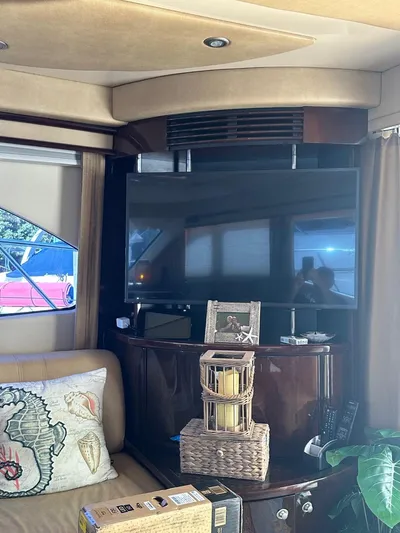 Meccabucks Yacht Photos Pics Interior of 2007 Sea Ray 52 Sedan Bridge with TV, decor, and seating area.