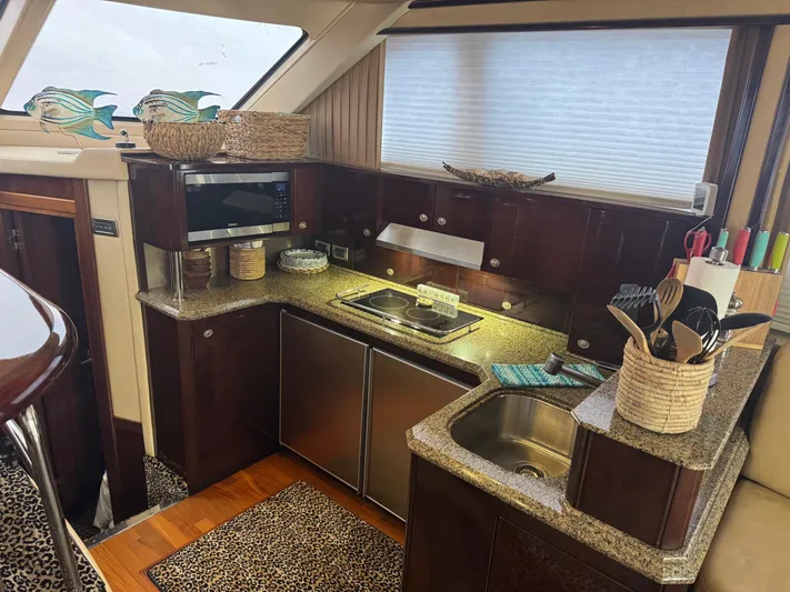 Meccabucks Yacht Photos Pics Luxurious 2007 Sea Ray 52 Sedan Bridge yacht kitchen with modern amenities and elegant design.