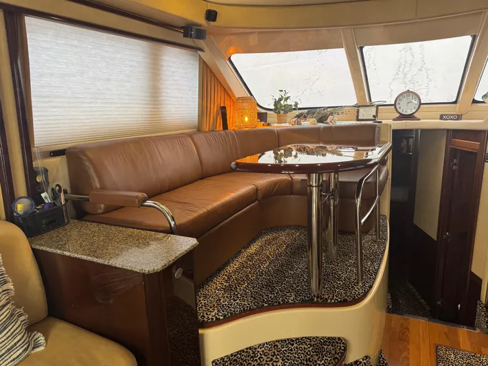 Meccabucks Yacht Photos Pics Luxurious interior of a 2007 Sea Ray 52 Sedan Bridge yacht with leather seating and elegant decor.