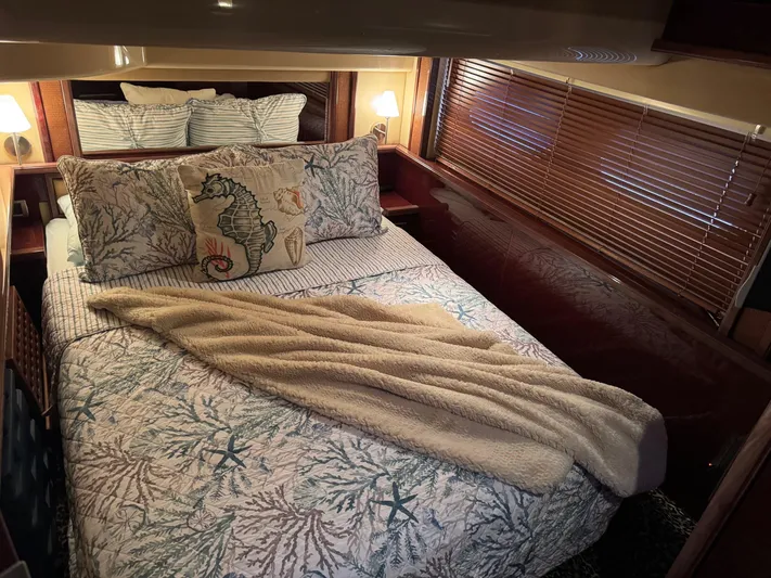 Meccabucks Yacht Photos Pics Luxurious bedroom interior of 2007 Sea Ray 52 Sedan Bridge yacht with nautical-themed decor.