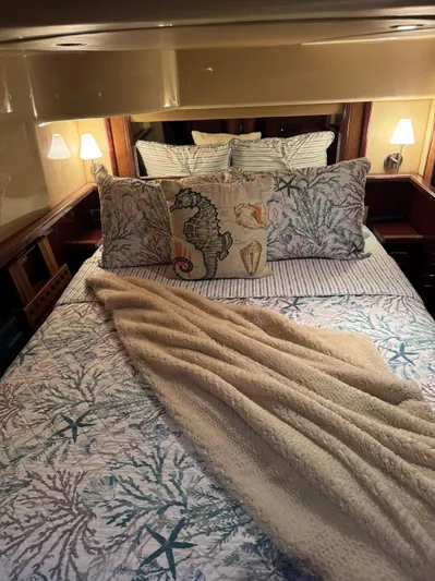 Meccabucks Yacht Photos Pics Cozy bedroom in 2007 Sea Ray 52 Sedan Bridge with nautical-themed bedding.