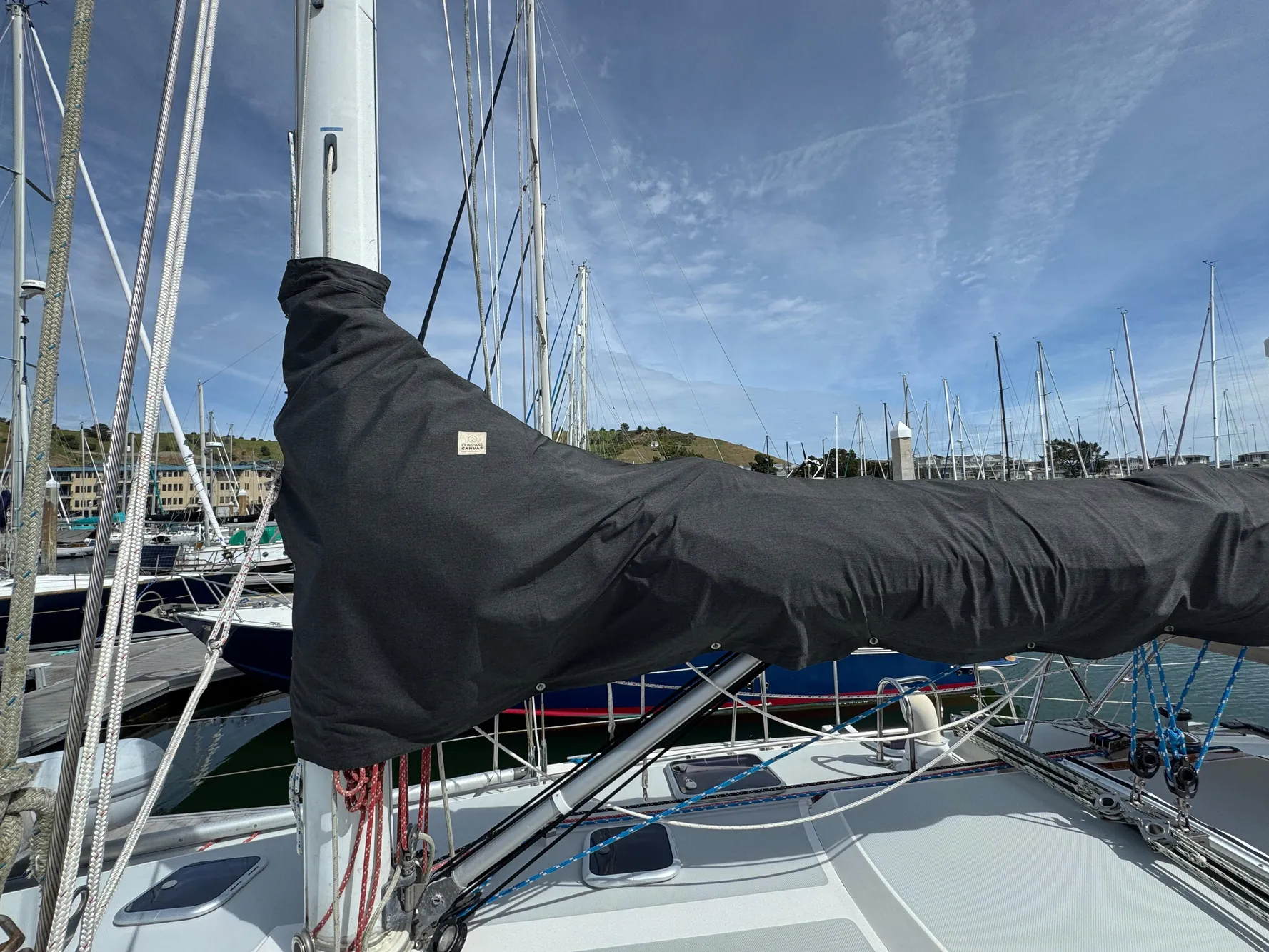 Sailboat mast and boom cover on a 1993 Catalina 42 in a marina.