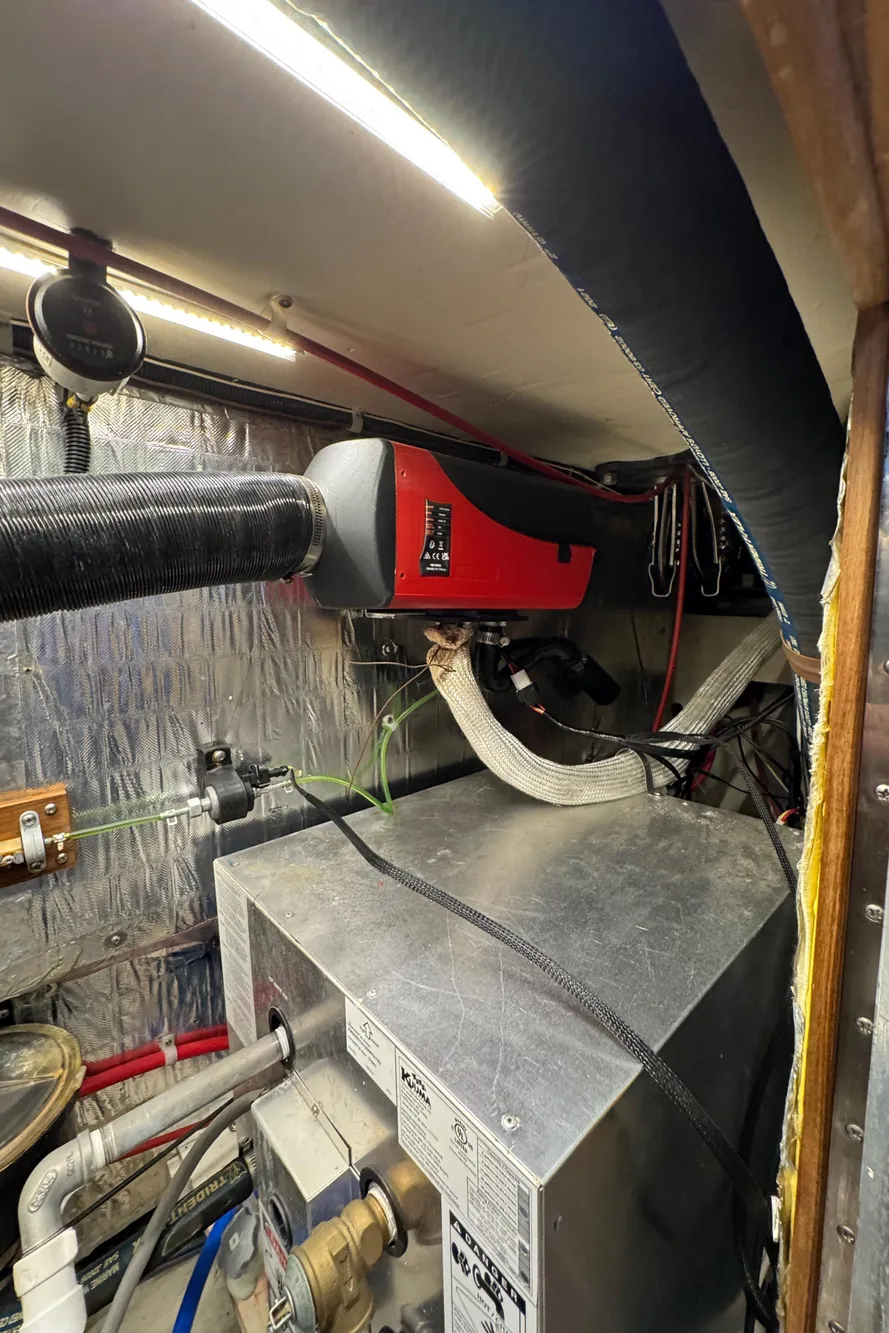 Engine room of a 1993 Catalina 42 sailboat with visible machinery and wiring.