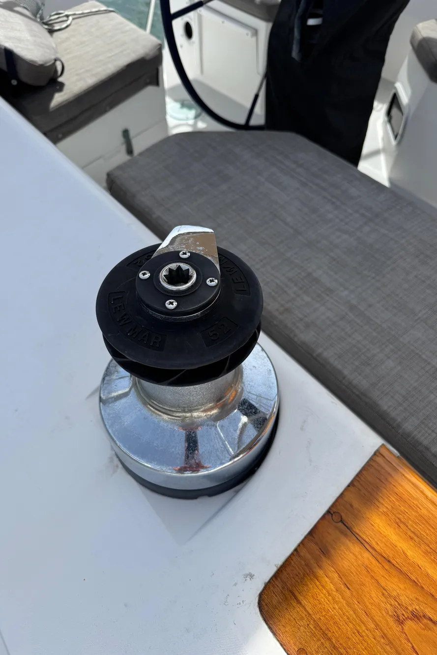 Winch on 1993 Catalina 42 sailboat deck, with seating and steering wheel visible.