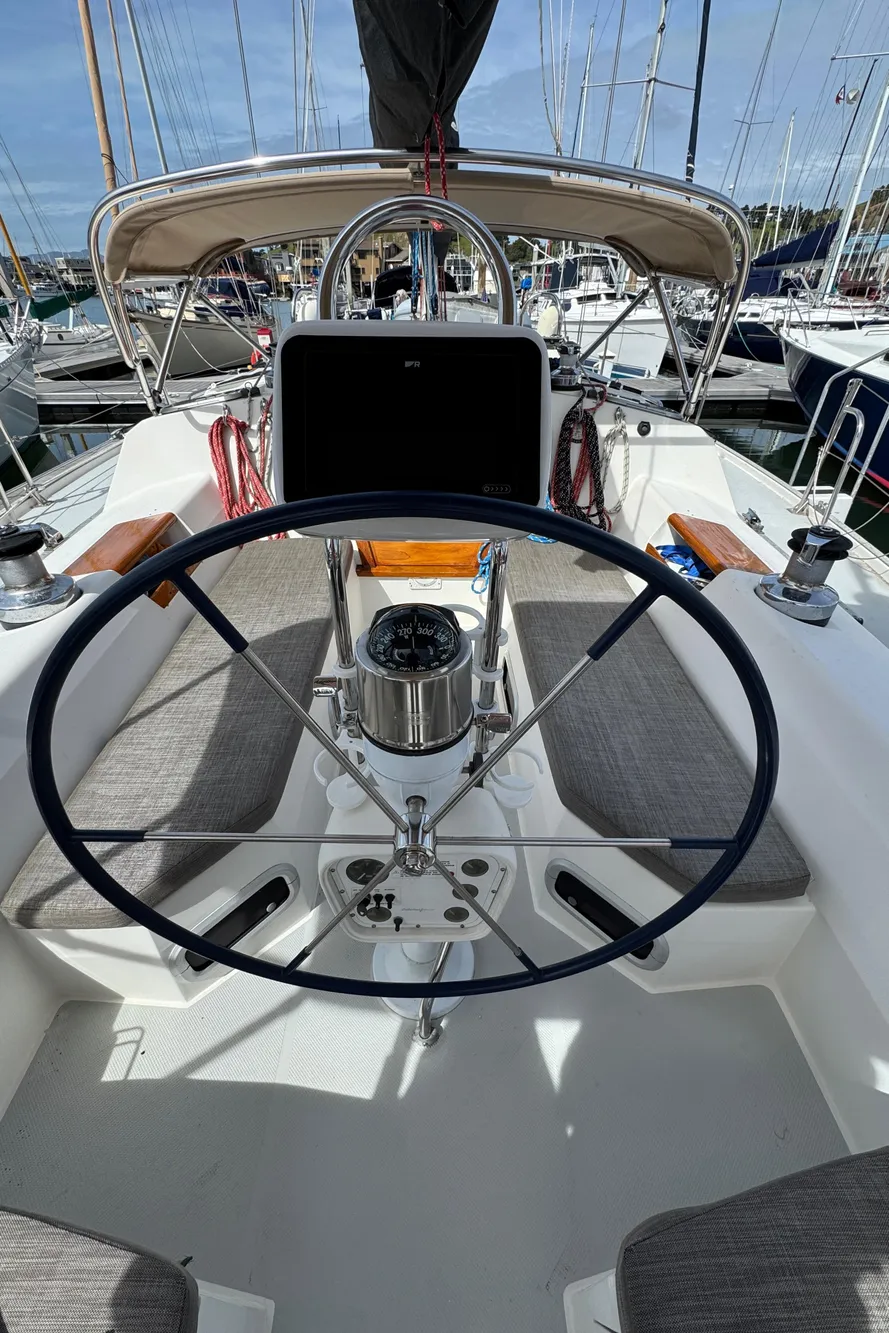 Cockpit of a 1993 Catalina 42 sailboat with steering wheel and navigation equipment.