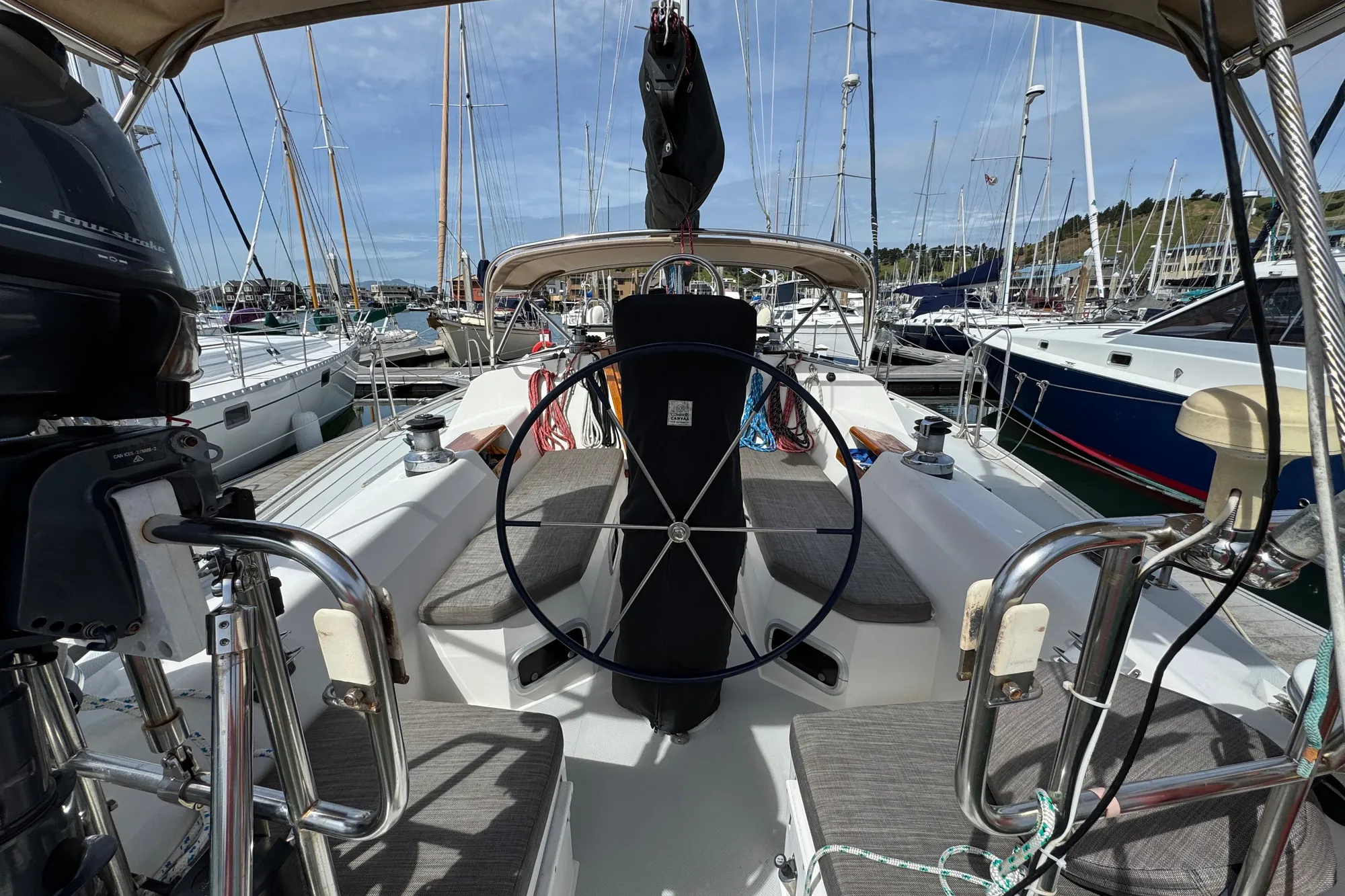 Cockpit view of a 1993 Catalina 42 sailboat docked in a marina.