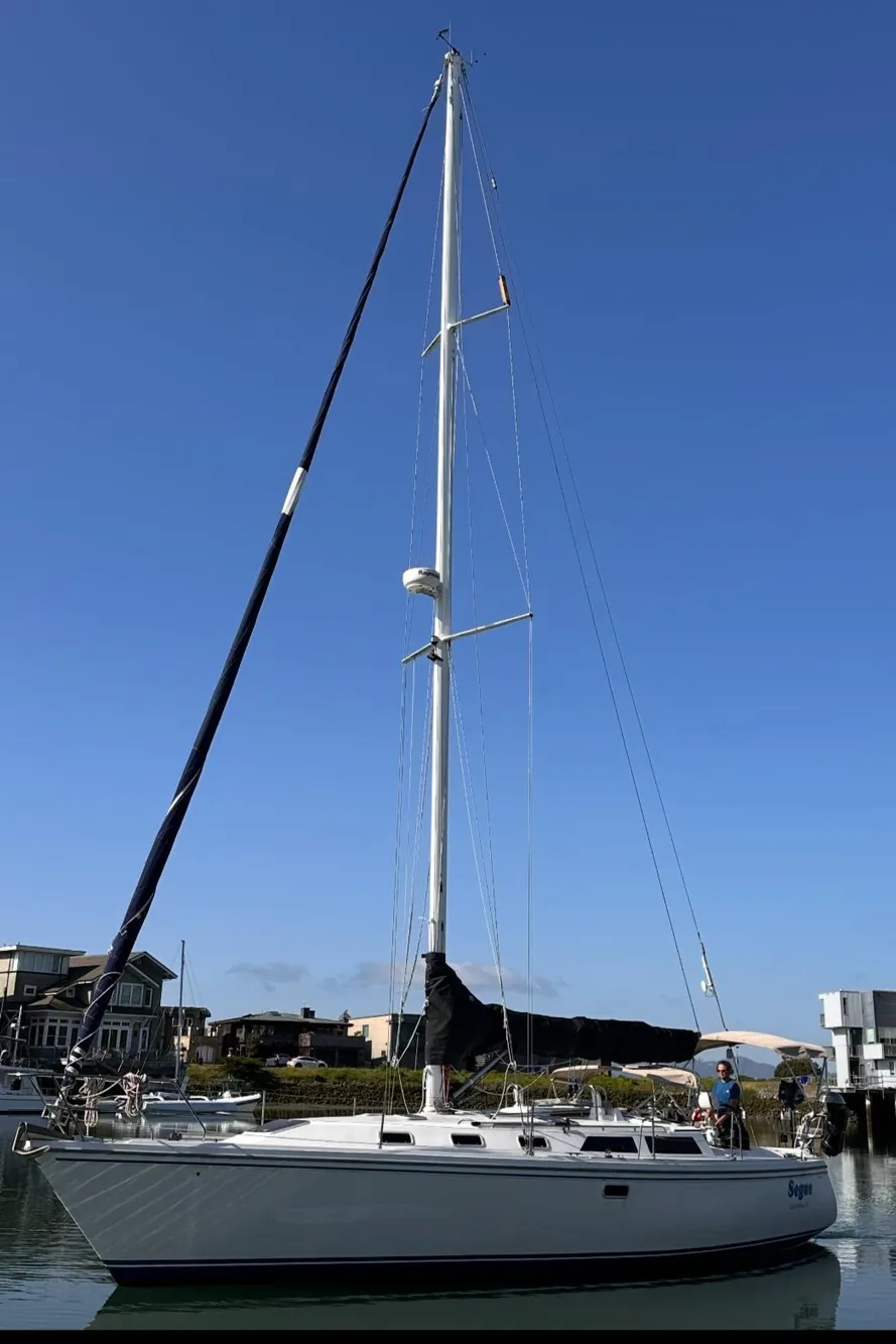 Catalina 42 sailboat from 1993 docked in a marina under clear blue skies.