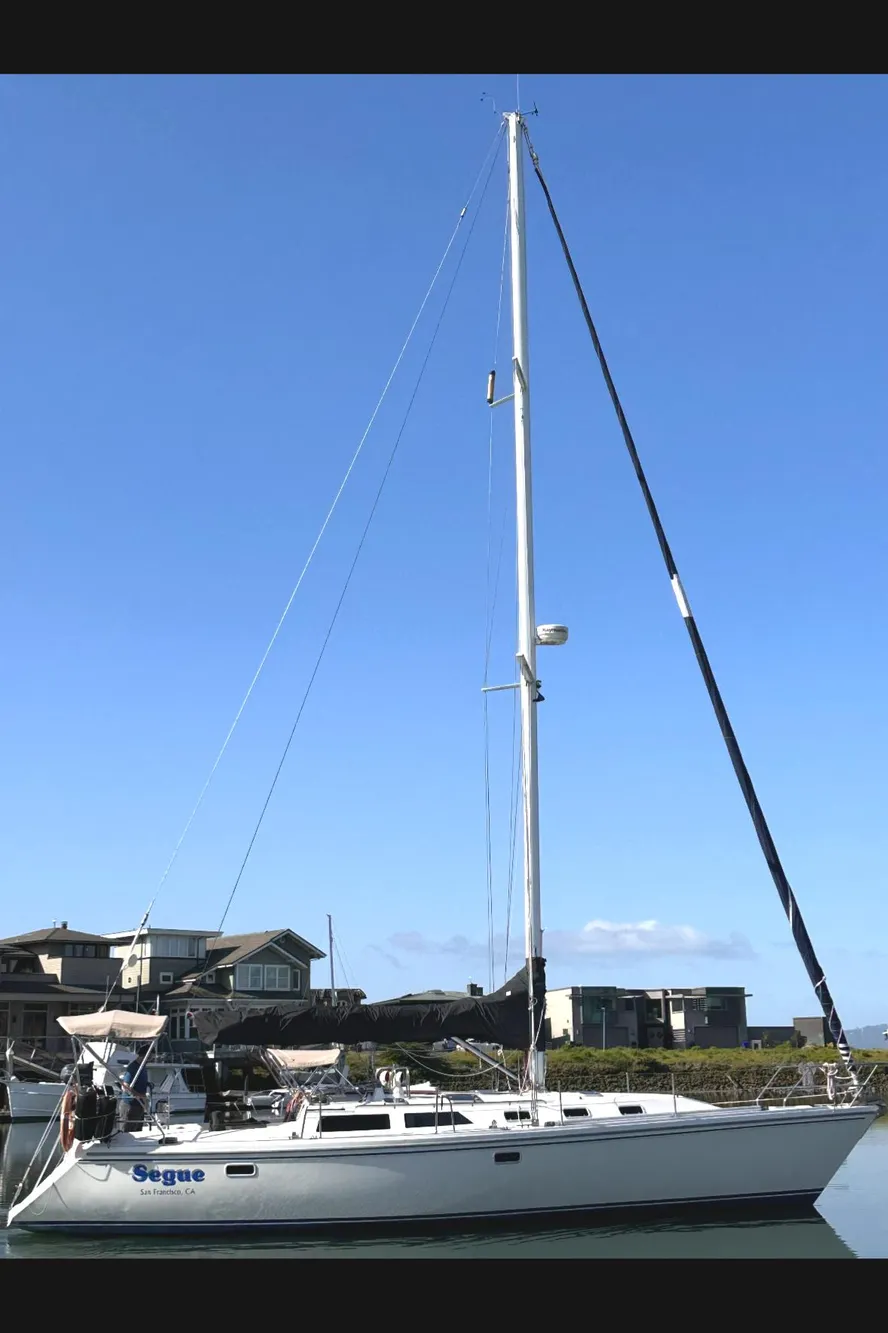 Sailboat Catalina 42, 1993 model, docked with clear blue sky background.