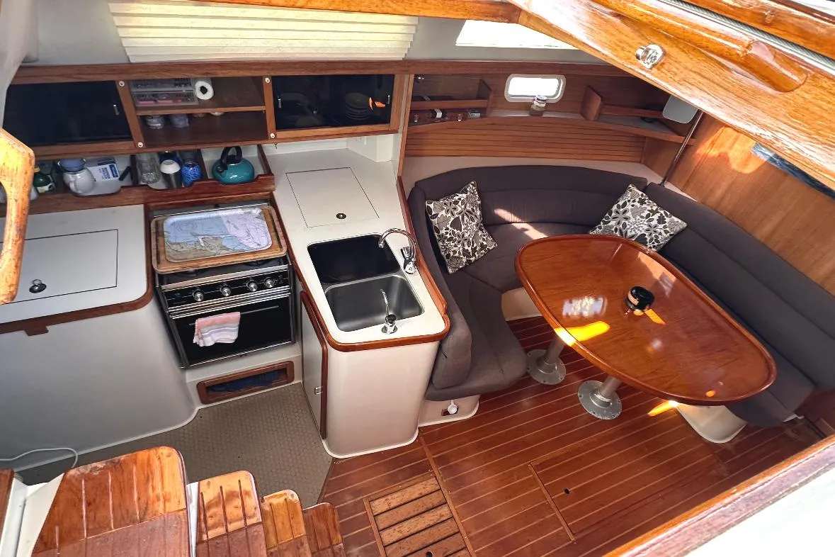 Interior of a 1993 Catalina 42 sailboat with kitchen and dining area.