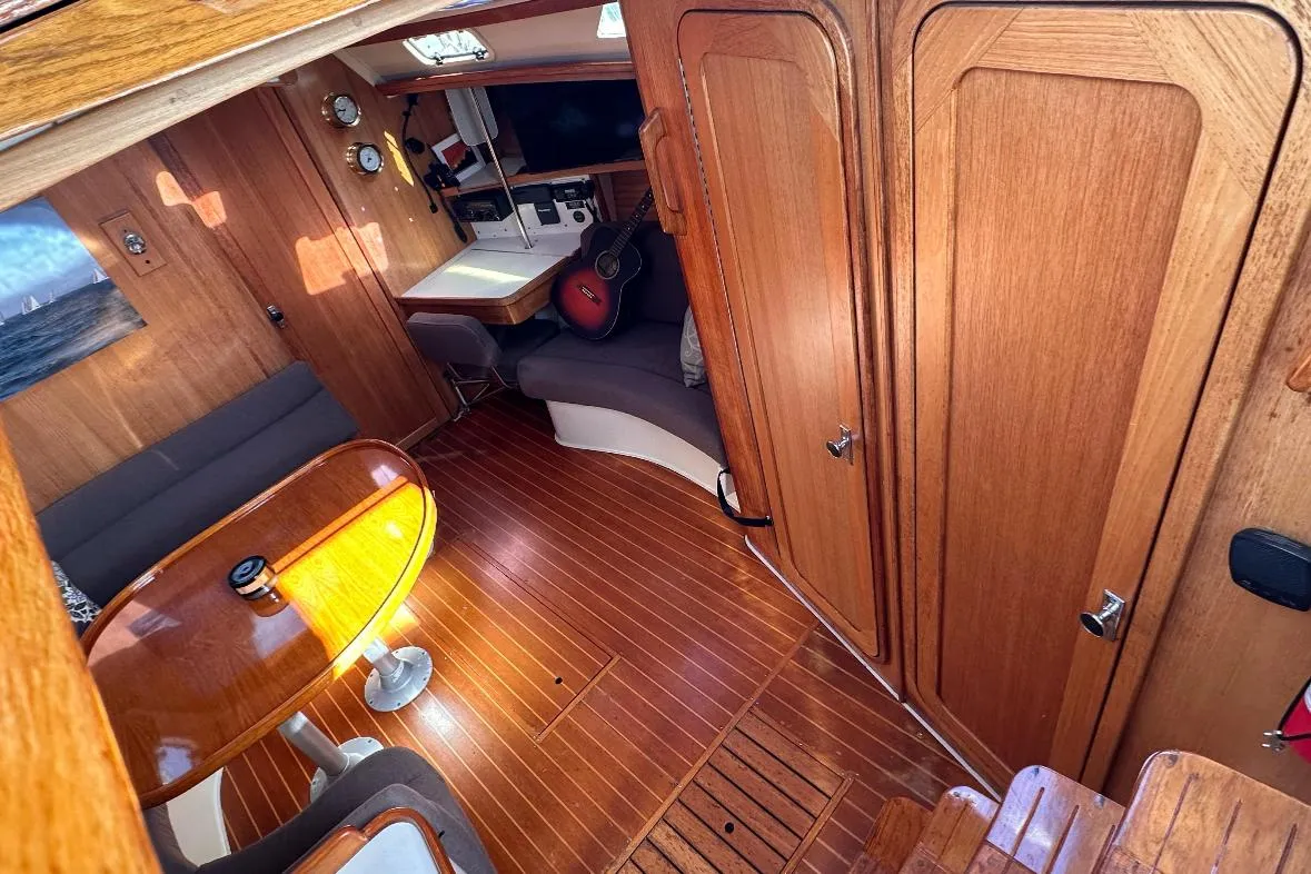 Interior of a 1993 Catalina 42 sailboat with wooden furnishings and seating area.