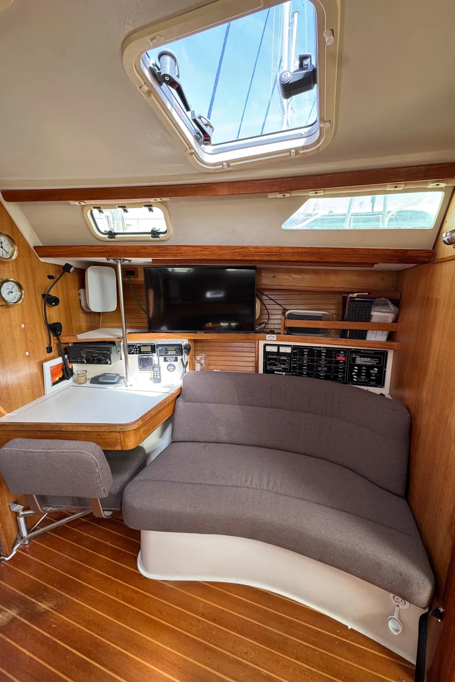 Interior of 1993 Catalina 42 sailboat with cozy seating and navigation station.