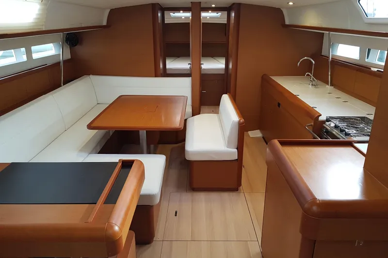 Fiesta Yacht Photos Pics Interior of 2019 Jeanneau Sun Odyssey 519 yacht with modern kitchen and seating area.