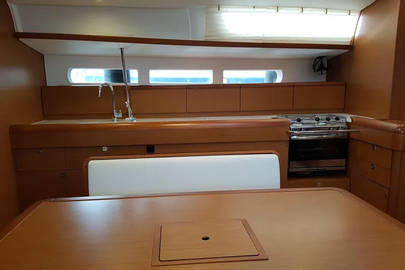Fiesta Yacht Photos Pics Interior of 2019 Jeanneau Sun Odyssey 519 yacht, featuring modern kitchen and dining area.