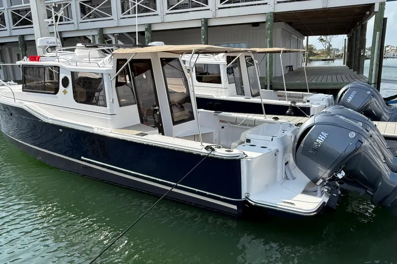  Yacht Photos Pics 2026 Ranger Tugs R-27 boat docked, featuring dual Yamaha outboard engines.