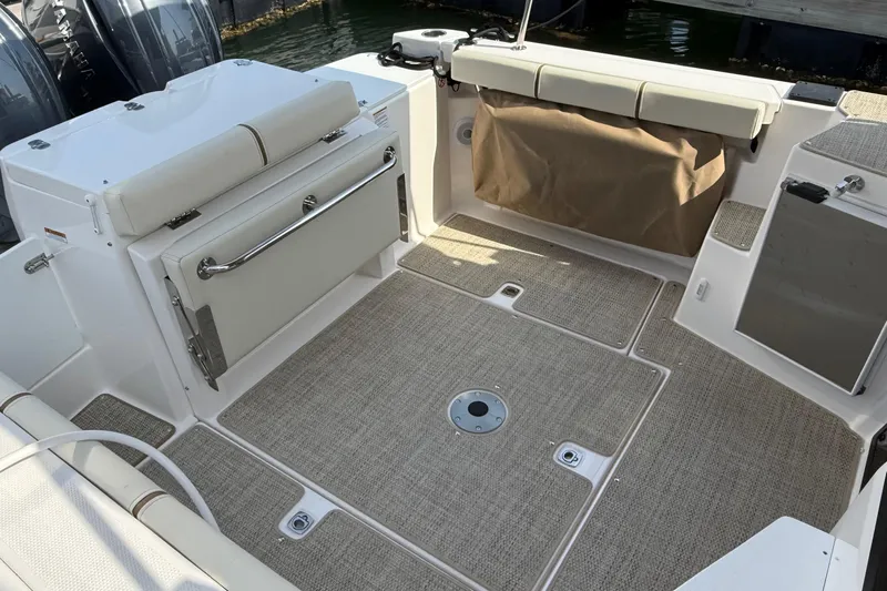  Yacht Photos Pics 2026 Ranger Tugs R-27 boat interior with cushioned seating and storage compartments.