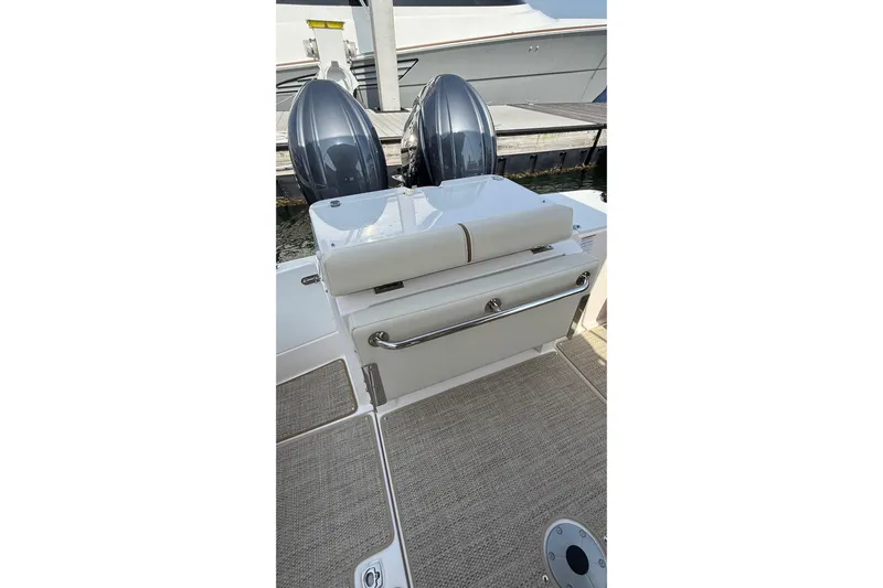  Yacht Photos Pics 2026 Ranger Tugs R-27 boat with dual outboard motors and cushioned seating.