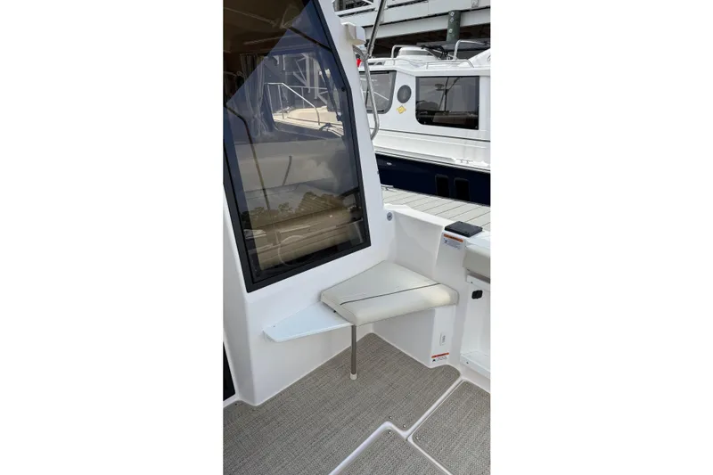 Yacht Photos Pics 2026 Ranger Tugs R-27 boat interior with seating and window view.