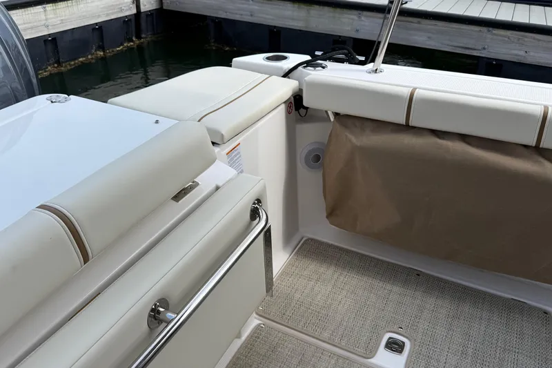  Yacht Photos Pics 2026 Ranger Tugs R-27 boat interior with cushioned seating and storage area.