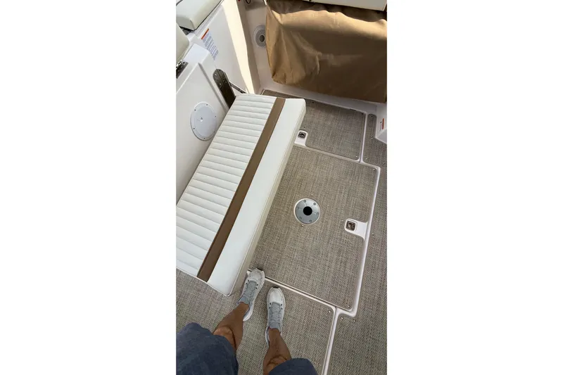  Yacht Photos Pics 2026 Ranger Tugs R-27 interior with cushioned seating and textured flooring.