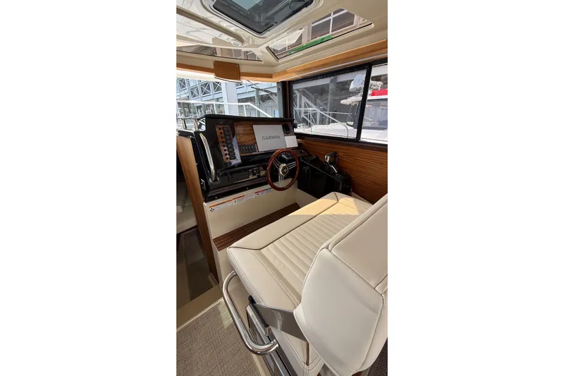  Yacht Photos Pics 2026 Ranger Tugs R-27 helm with Garmin navigation, luxurious seating, and modern controls.