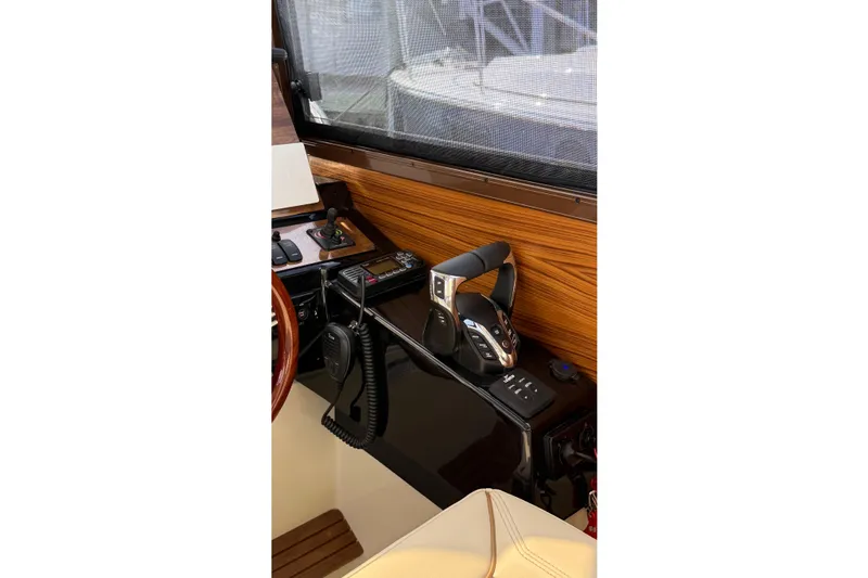  Yacht Photos Pics 2026 Ranger Tugs R-27 helm station with modern controls and wood paneling.