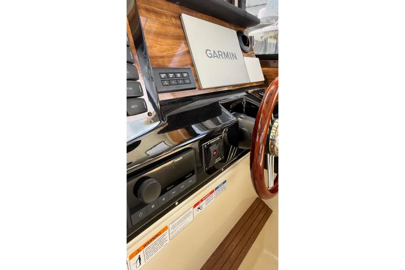  Yacht Photos Pics 2026 Ranger Tugs R-27 helm with Garmin navigation and wood accents.