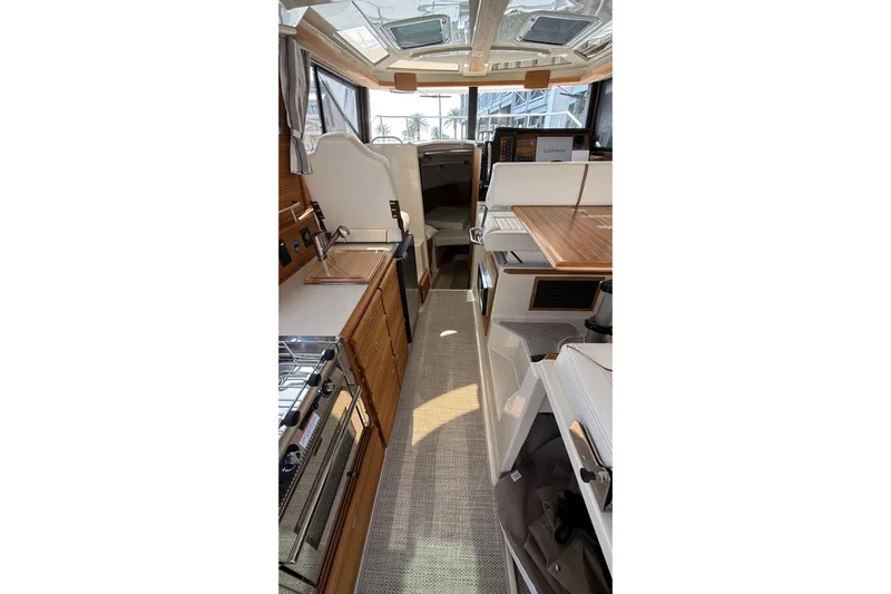  Yacht Photos Pics Interior of 2026 Ranger Tugs R-27, featuring modern kitchen and seating area.