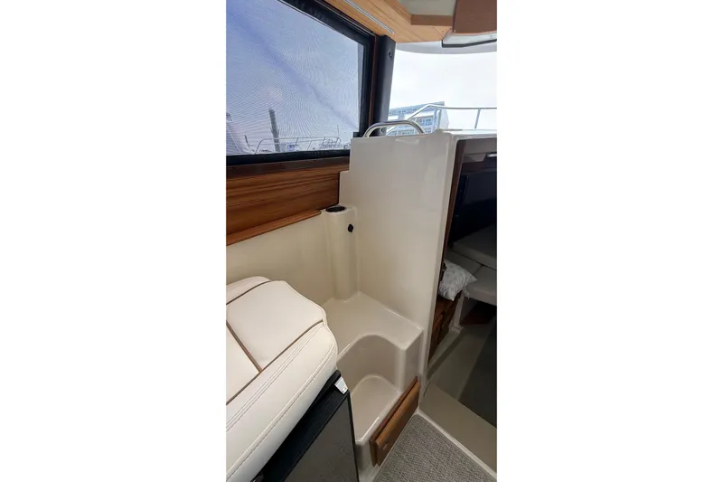  Yacht Photos Pics 2026 Ranger Tugs R-27 interior with seating and window view.