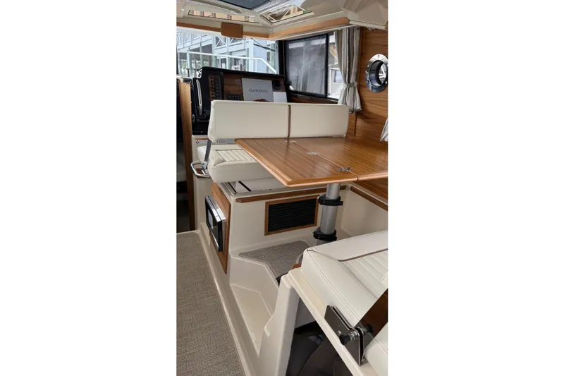  Yacht Photos Pics Interior of 2026 Ranger Tugs R-27, featuring elegant wood and leather seating.