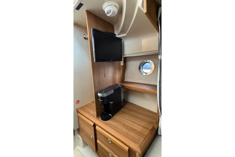 Yacht Photos Pics Interior of 2026 Ranger Tugs R-27 with TV, coffee maker, and porthole window.