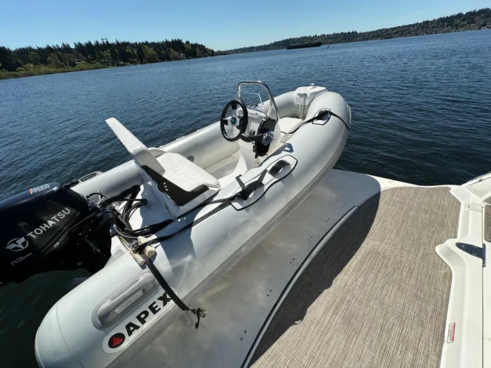  Yacht Photos Pics Apex inflatable boat with Tohatsu motor on Sea Ray 340 Sundancer, 2004 model, docked on a lake.