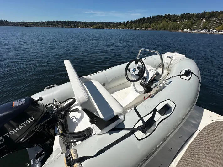  Yacht Photos Pics Inflatable boat with Tohatsu motor on calm lake, near 2004 Sea Ray 340 Sundancer.