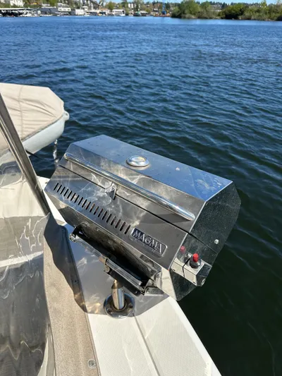  Yacht Photos Pics Stainless steel grill on a 2004 Sea Ray 340 Sundancer boat by the water.