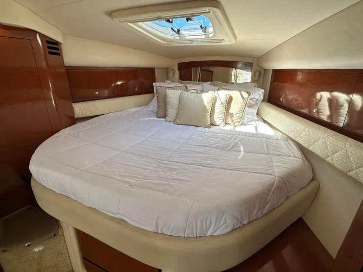  Yacht Photos Pics Luxurious cabin interior of 2004 Sea Ray 340 Sundancer with plush bedding and skylight.