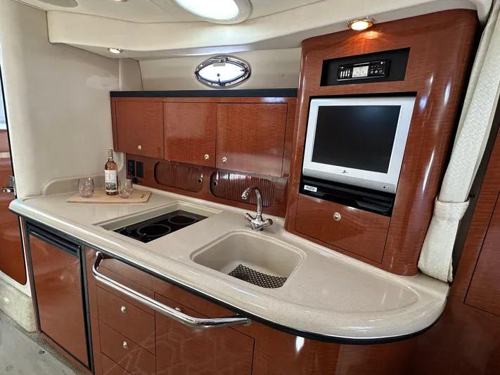  Yacht Photos Pics 2004 Sea Ray 340 Sundancer interior with kitchenette, sink, and TV.